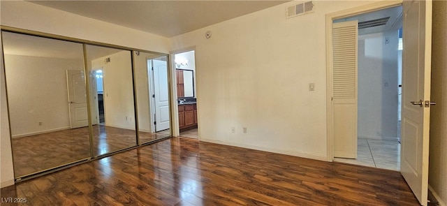 3145 E Flamingo Rd Unit 2005, Las Vegas, NV 89121 - unfurnished bedroom featuring wood finished floors and connected bathroom