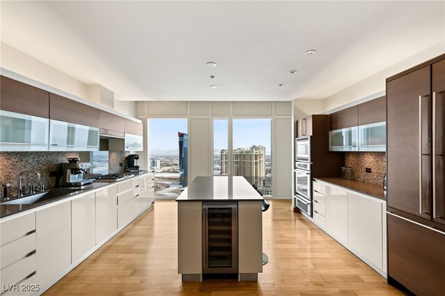 3750 Las Vegas Blvd Unit 3008, Las Vegas, NV 89158 - kitchen featuring wine cooler, modern cabinets, backsplash, a sink, and recessed lighting