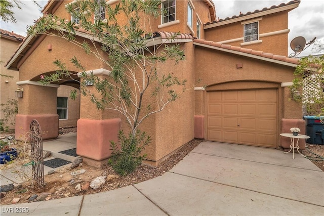 5050 Secret Rock St, Las Vegas, NV 89122 - view of front of house with stucco siding, driveway, a tile roof, and an attached garage