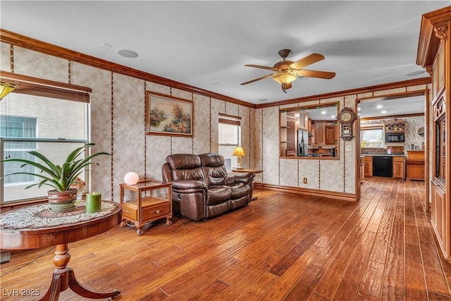 5050 Secret Rock St, Las Vegas, NV 89122 - living room featuring hardwood / wood-style floors, ornamental molding, a ceiling fan, and wallpapered walls
