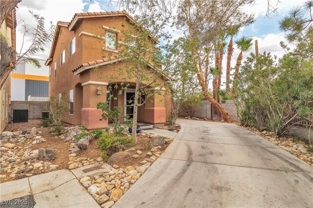 5050 Secret Rock St, Las Vegas, NV 89122 - view of front of house featuring driveway, a tiled roof, and stucco siding