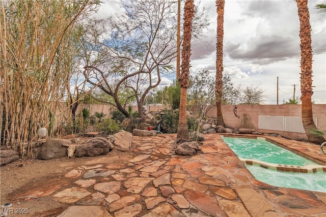 5050 Secret Rock St, Las Vegas, NV 89122 - fenced backyard with an outdoor hot tub