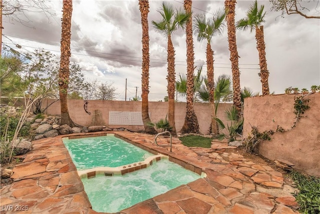 5050 Secret Rock St, Las Vegas, NV 89122 - view of swimming pool with an in-ground hot tub, a fenced backyard, and a patio area