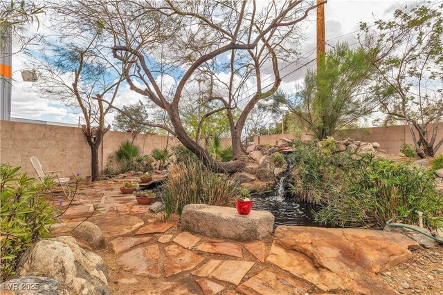 5050 Secret Rock St, Las Vegas, NV 89122 - fenced backyard with a patio area