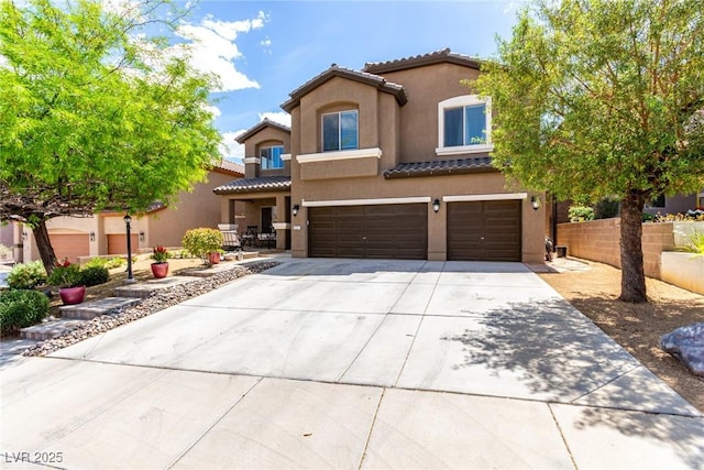 mediterranean / spanish-style home with an attached garage, stucco siding, driveway, and a tiled roof
