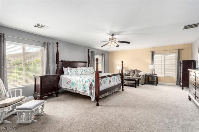 bedroom featuring baseboards, a ceiling fan, light colored carpet, and visible vents