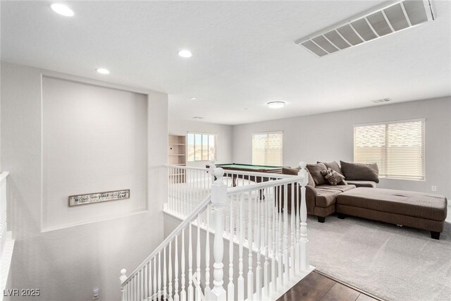 stairs featuring visible vents, recessed lighting, and wood finished floors