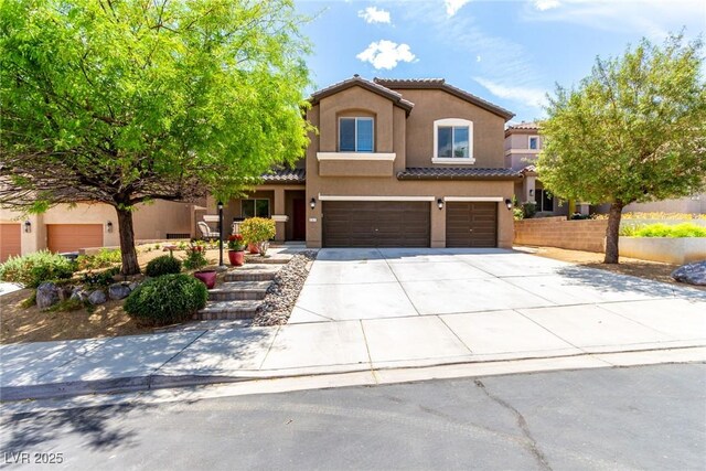 mediterranean / spanish-style house featuring an attached garage, stucco siding, driveway, and a tiled roof
