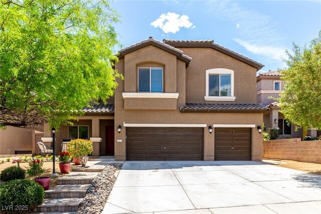 mediterranean / spanish-style home featuring a garage, a tiled roof, driveway, and stucco siding