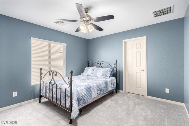 carpeted bedroom featuring visible vents, a ceiling fan, and baseboards