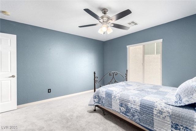 carpeted bedroom featuring baseboards, ceiling fan, and visible vents