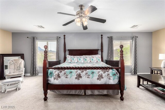 carpeted bedroom featuring visible vents, baseboards, and multiple windows