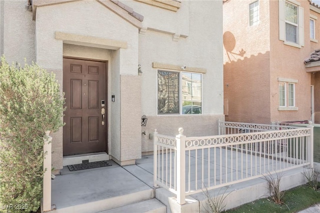 7649 Calico Fields St, Las Vegas, NV 89149 - doorway to property with stucco siding and fence