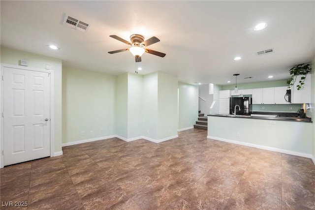 7649 Calico Fields St, Las Vegas, NV 89149 - kitchen with white cabinetry, visible vents, dark countertops, and a ceiling fan