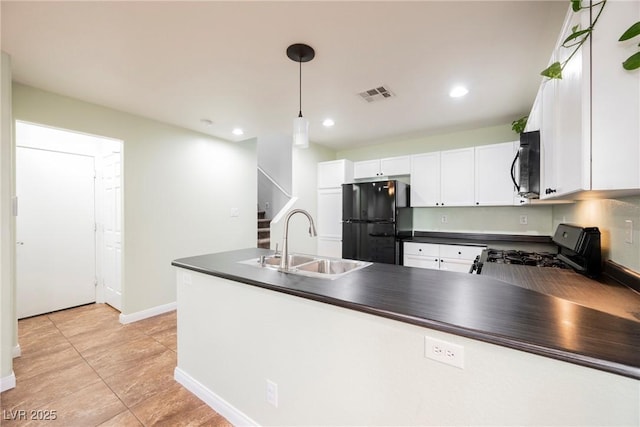 7649 Calico Fields St, Las Vegas, NV 89149 - kitchen with a sink, a peninsula, dark countertops, visible vents, and black appliances