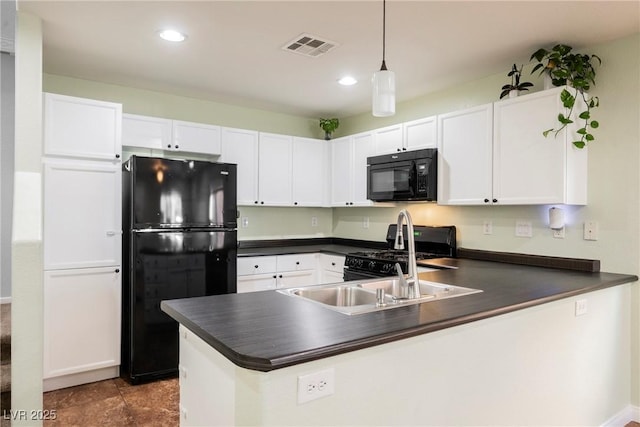 7649 Calico Fields St, Las Vegas, NV 89149 - kitchen with dark countertops, visible vents, white cabinets, a peninsula, and black appliances