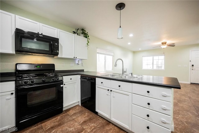 7649 Calico Fields St, Las Vegas, NV 89149 - kitchen with dark countertops, black appliances, a sink, and a peninsula