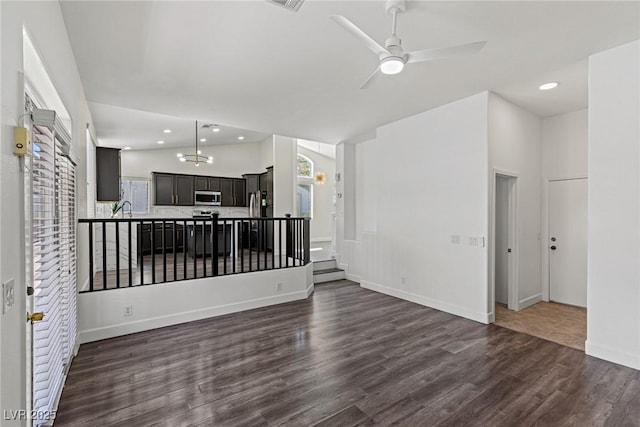 unfurnished living room featuring a sink, lofted ceiling, ceiling fan, recessed lighting, and dark wood-style flooring