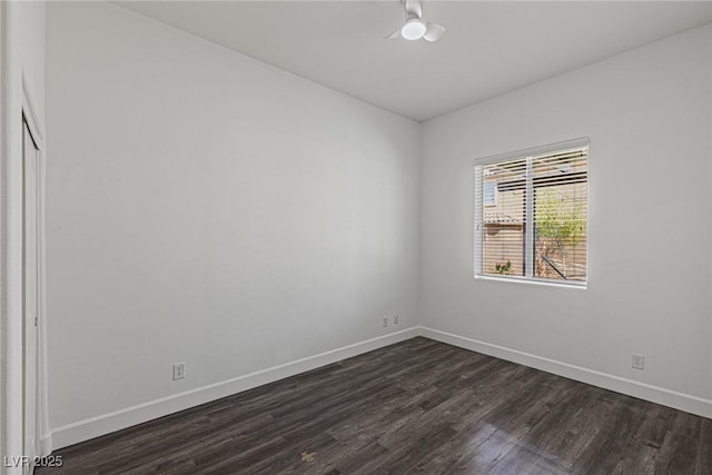 unfurnished room with baseboards and dark wood-style flooring