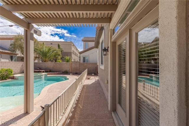 view of swimming pool with a patio, a fenced backyard, and a pool with connected hot tub