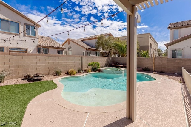 view of pool featuring a fenced backyard, a fire pit, a pool with connected hot tub, and a patio area