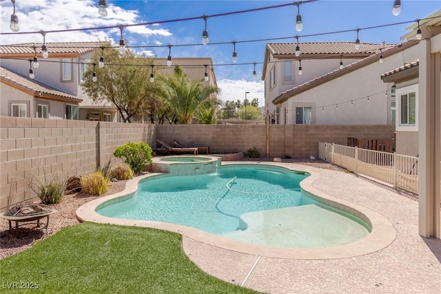 view of pool featuring a fenced backyard and a pool with connected hot tub