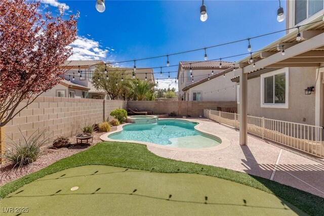 view of pool with a fenced backyard, a pool with connected hot tub, and a patio area