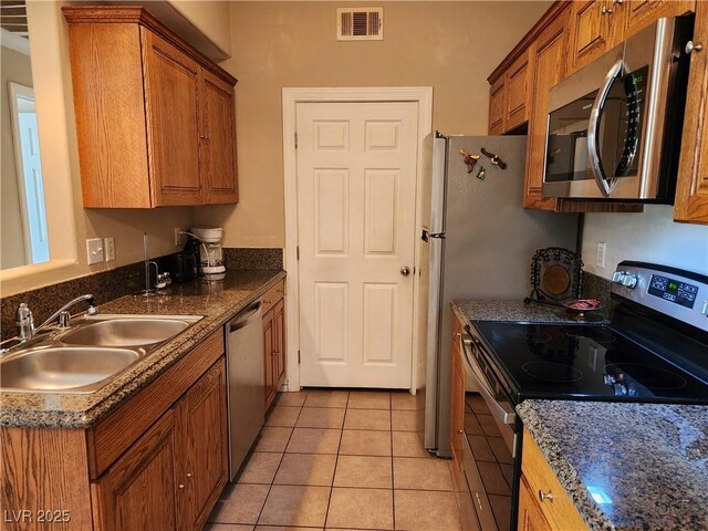 3550 Bay Sands Dr Unit 3077, Laughlin, NV 89029 - kitchen featuring a sink, stainless steel appliances, brown cabinetry, and visible vents