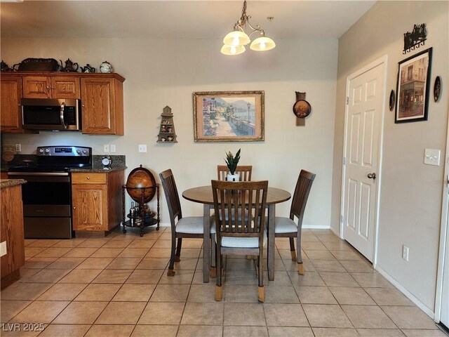 3550 Bay Sands Dr Unit 3077, Laughlin, NV 89029 - dining area featuring baseboards, a chandelier, and light tile patterned floors