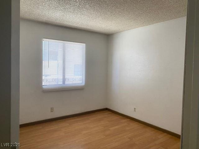 7732 Blackbird Ave, Las Vegas, NV 89145 - empty room featuring a textured ceiling and light wood-style floors