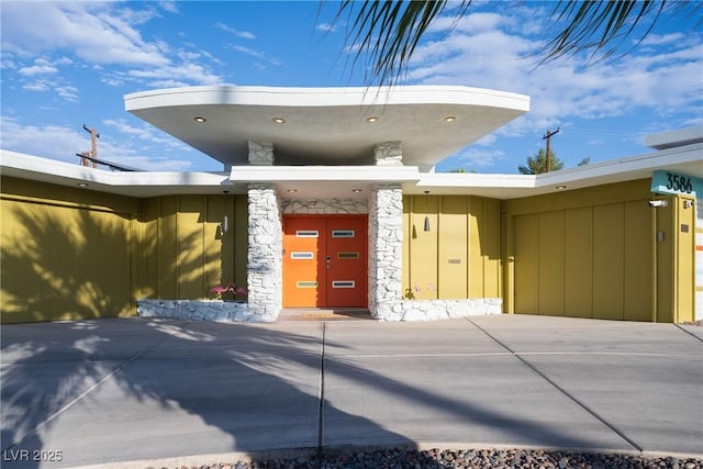3586 Spencer St, Las Vegas, NV 89169 - doorway to property with stone siding and board and batten siding