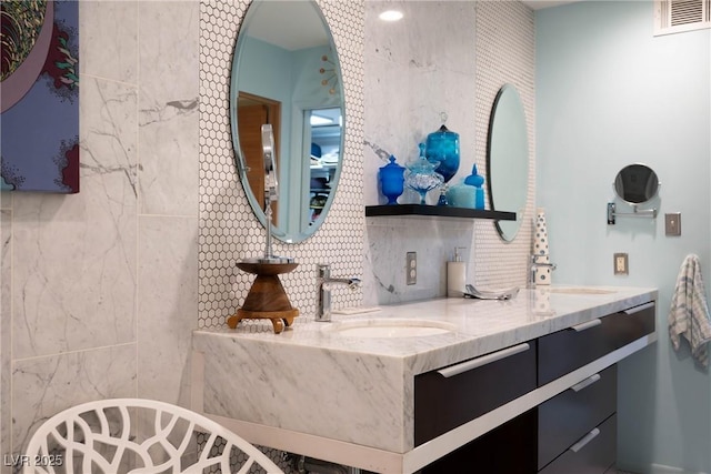 3586 Spencer St, Las Vegas, NV 89169 - full bathroom with double vanity, a sink, tasteful backsplash, and visible vents