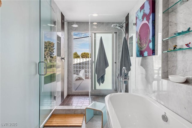 3586 Spencer St, Las Vegas, NV 89169 - bathroom featuring a stall shower, tile patterned floors, a freestanding tub, and tile walls