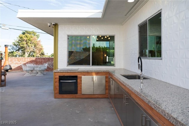 3586 Spencer St, Las Vegas, NV 89169 - view of patio / terrace featuring outdoor dining area, a sink, fence, and area for grilling