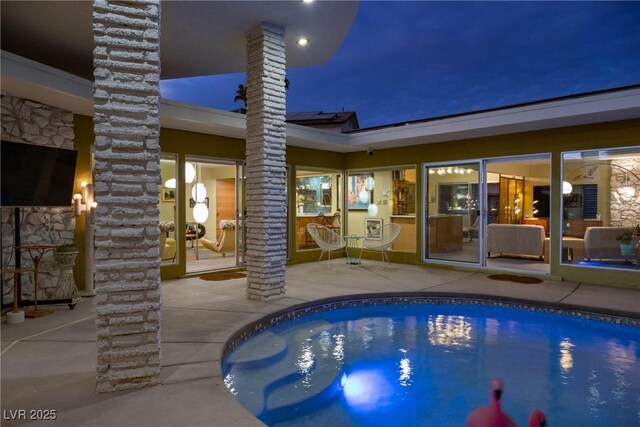 3586 Spencer St, Las Vegas, NV 89169 - pool at night with an outdoor pool and a patio area