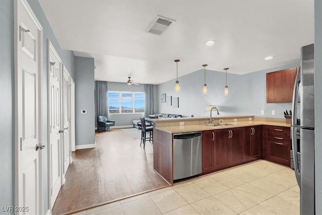150 Las Vegas Blvd Unit 918, Las Vegas, NV 89101 - kitchen featuring stainless steel appliances, a sink, a peninsula, pendant lighting, and a ceiling fan