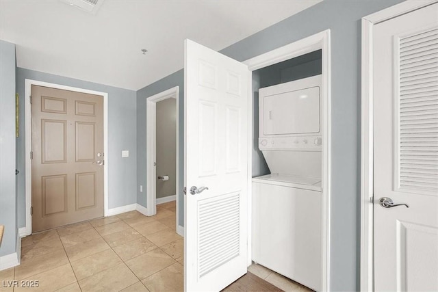 150 Las Vegas Blvd Unit 918, Las Vegas, NV 89101 - washroom featuring stacked washer and clothes dryer, baseboards, and light tile patterned flooring