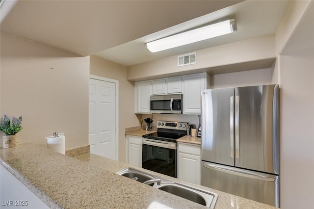 8000 Badura Ave Unit 2063, Las Vegas, NV 89113 - kitchen featuring appliances with stainless steel finishes, white cabinets, and a sink