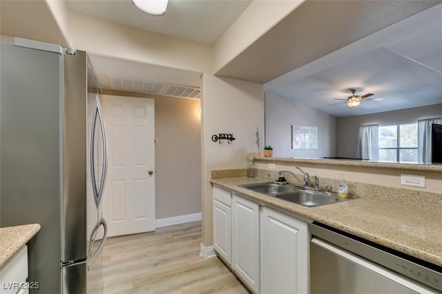 8000 Badura Ave Unit 2063, Las Vegas, NV 89113 - kitchen with stainless steel appliances, a sink, white cabinets, and light countertops