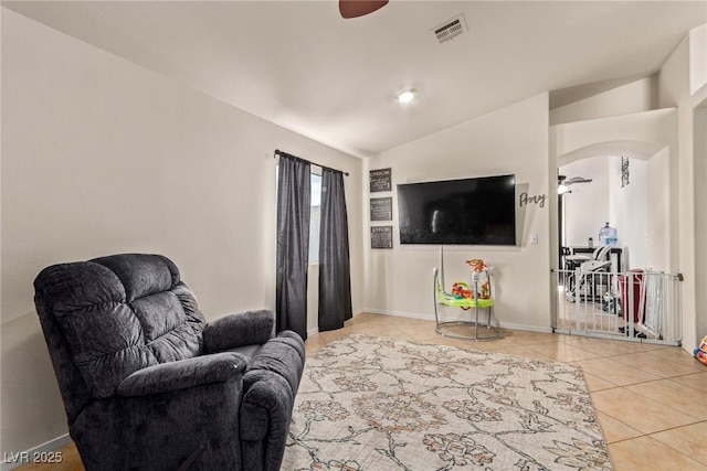 living room with arched walkways, ceiling fan, tile patterned flooring, and visible vents