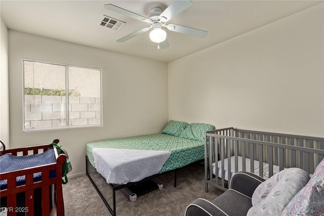 bedroom with ceiling fan, visible vents, and carpet floors