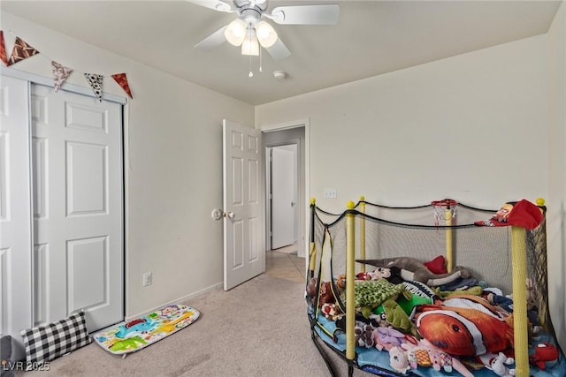 bedroom featuring light carpet and ceiling fan