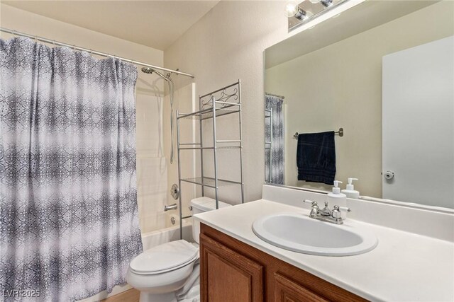 bathroom featuring shower / bath combo with shower curtain, vanity, and toilet
