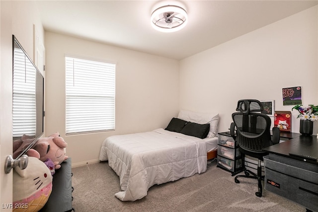 carpeted bedroom featuring baseboards