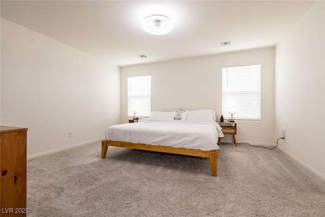 carpeted bedroom featuring visible vents and baseboards
