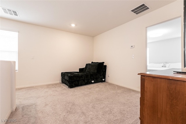 unfurnished room featuring carpet, visible vents, and baseboards