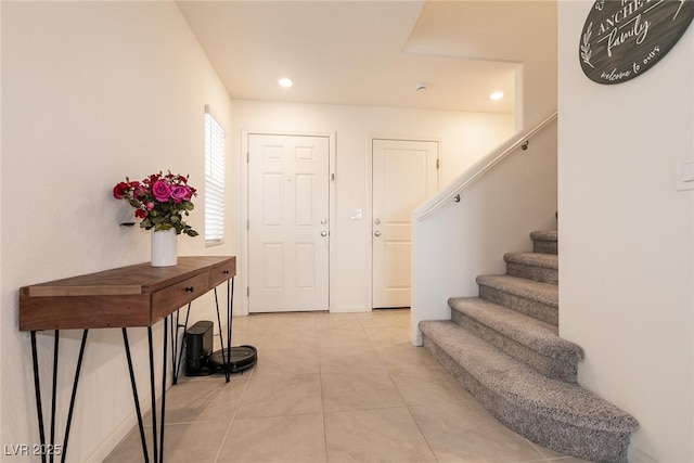 foyer with light tile patterned flooring, recessed lighting, and stairs