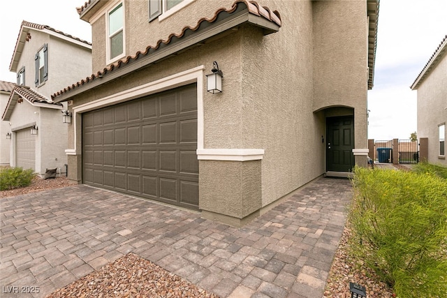 garage with decorative driveway