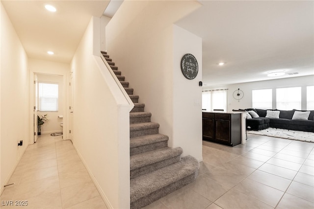 staircase featuring visible vents, baseboards, recessed lighting, and tile patterned flooring