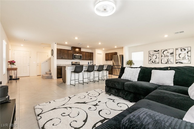 living area with recessed lighting, light tile patterned floors, and visible vents